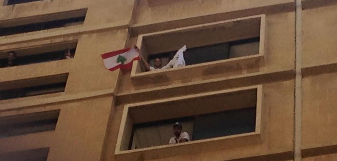 In action - Amir, one of the organizers of the YouStink-movement, waving the Lebanese flag. Photo: Private.