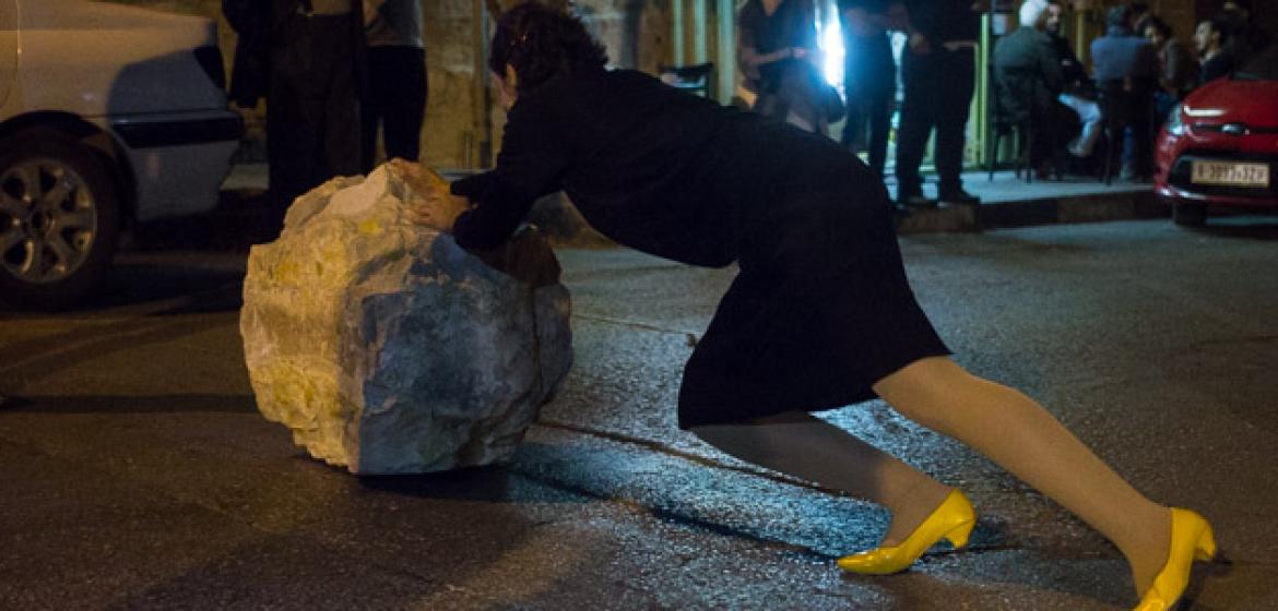 Das schwarze Kleid und die gelben Pumps der Künstlerin erinnern an ein ikonisches Foto der ersten Intifada – eine steinewerfende Frau, noch im Kostüm des sonntäglichen Kirchgangs. Foto: Jan Hennies.