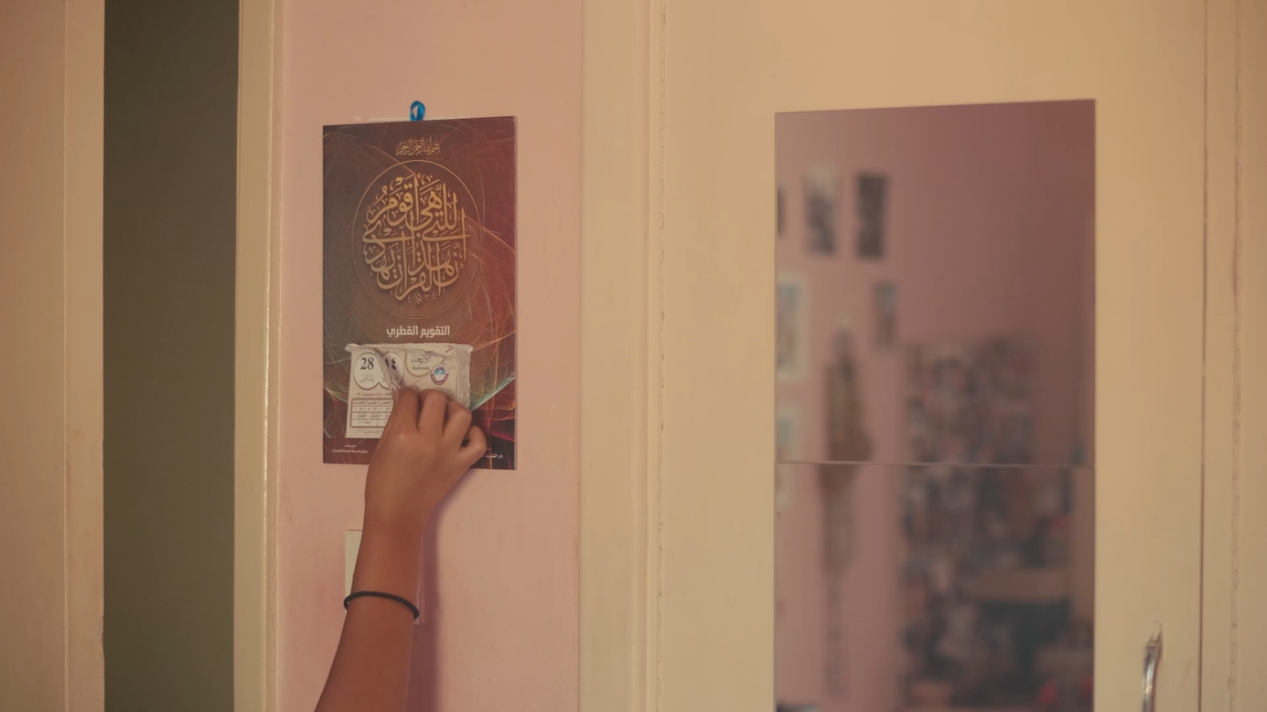 A still from the movie: Removing a calendar page. Credit: Eiman Mirghani